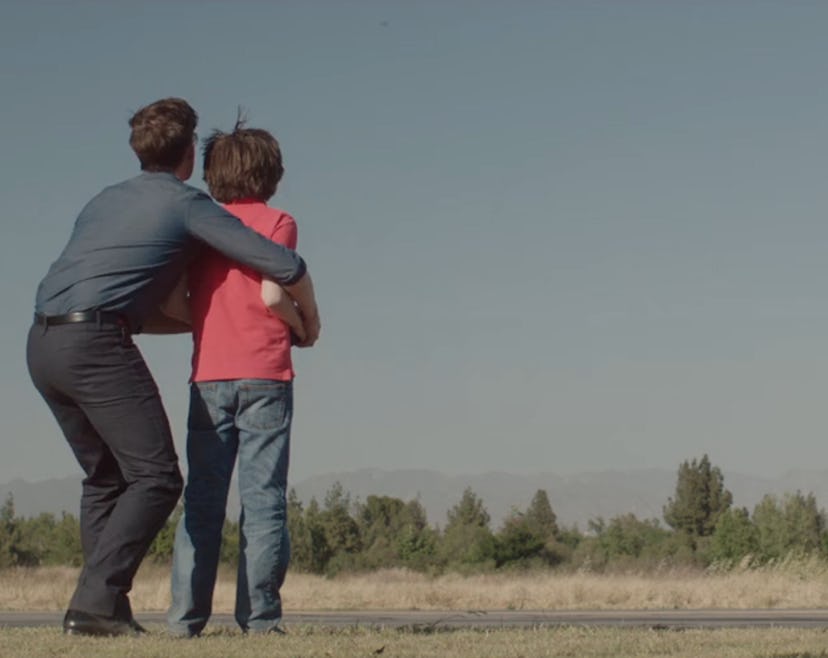 A scene from 'A Boy Called Po' movie showing Christopher Gorham hugging Julian Feder as they are loo...