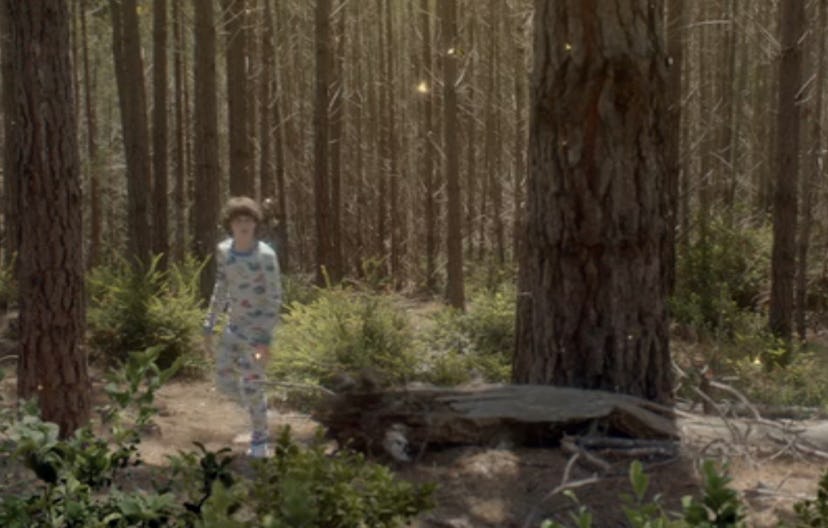 A scene from 'A Boy Called Po' movie showing Julian Feder as Po being in the forest in PJs.