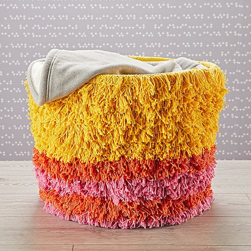 Storage bin with yellow, red and pink tassels reminding of Big Bird character.