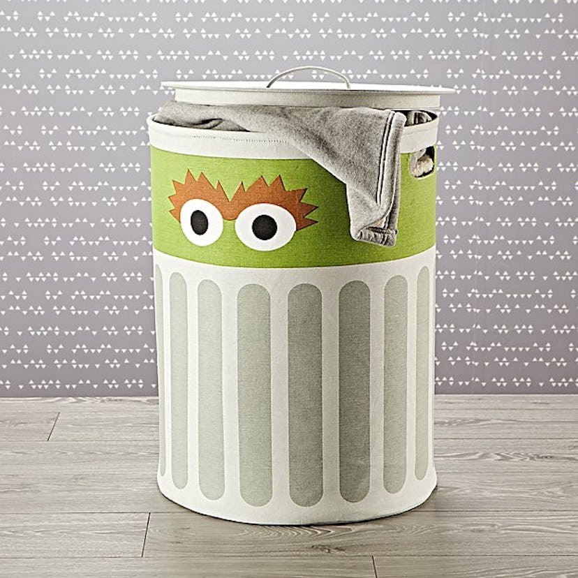 Oscar the Grouch hamper with a blanket in it.