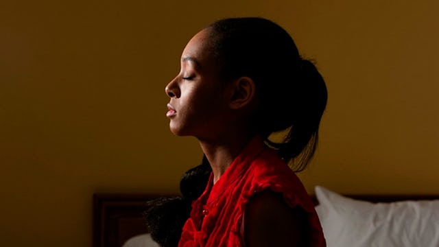 A Woman Turned To The Side With Her Eyes Closed