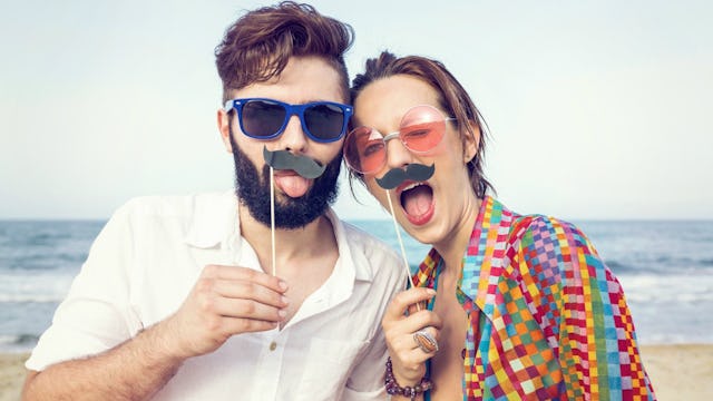 A couple having fun on the beach like an adult-child