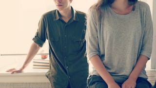 A couple that gave up on divorce and are still married, standing next to each other in the kitchen