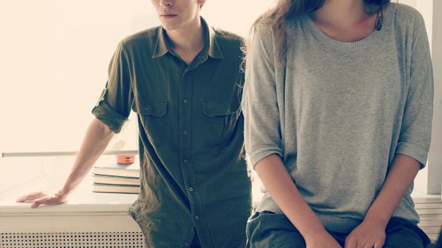 A couple that gave up on divorce and are still married, standing next to each other in the kitchen