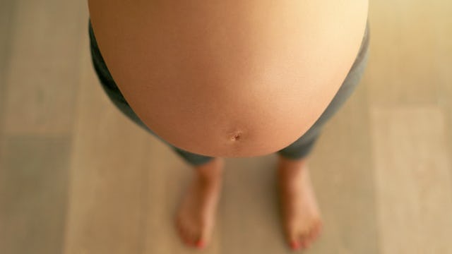 Pregnant woman showing her pregnancy belly after her due date