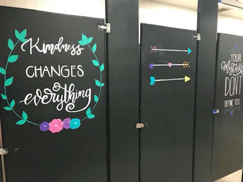 kindness changes everything painted on a bathroom stall