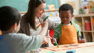 Two kids in art class with their teacher