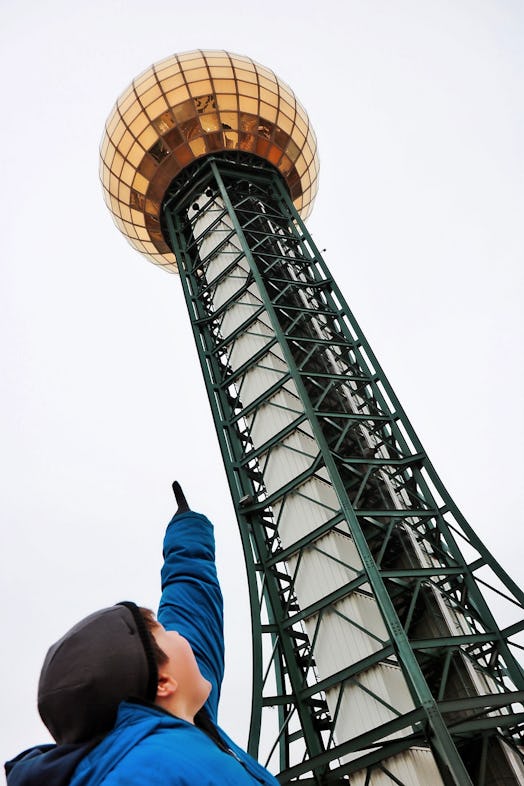 A small boy pointing his index finger on the Knoxville Sunsphere elevator