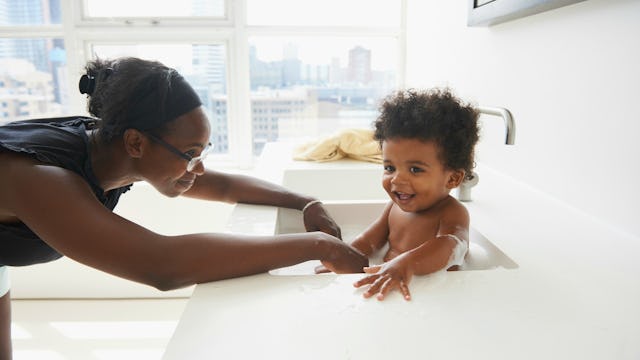 Mom giving her child a bath