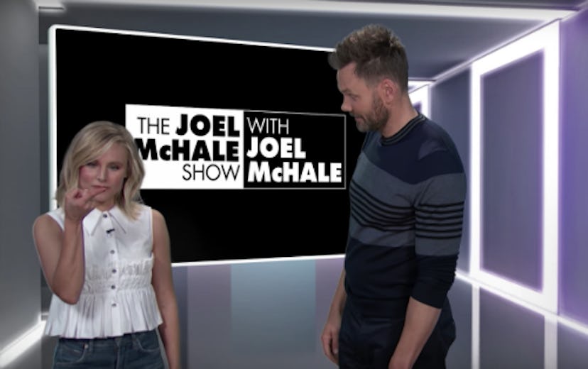 Kristen Bell explaining something to Joel McHale in his show