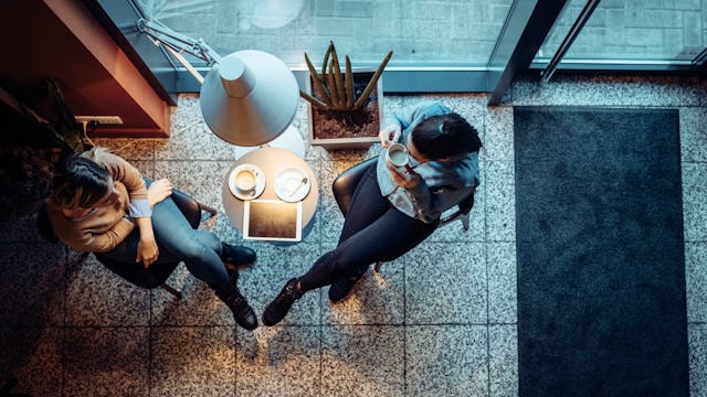 Two women having a conversation at a café 