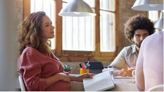 pregnant woman working in an office