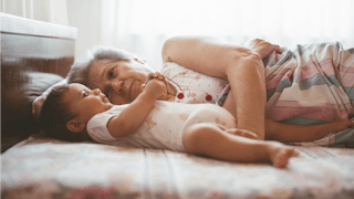 Grandma Laying In Bed With A Baby 