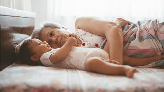 Grandma Laying In Bed With A Baby