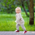 A happy toddler who is running in a park