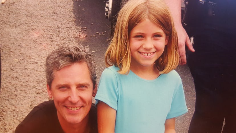 A young Tina Drakakis wearing a blue t-shirt smiling with Douglas Wilson 