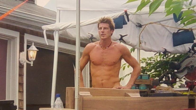 Shirtless Ty Pennington standing with arms on his hips 