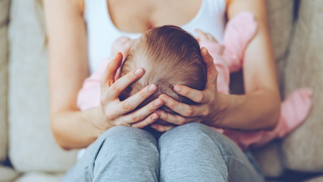 A mother holding her baby on her lap
