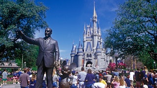 A Disney World location with a statue of Walt Disney
