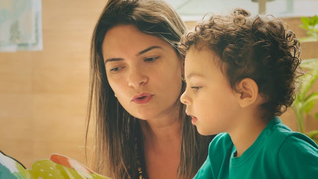 A woman and her stepson reading a book