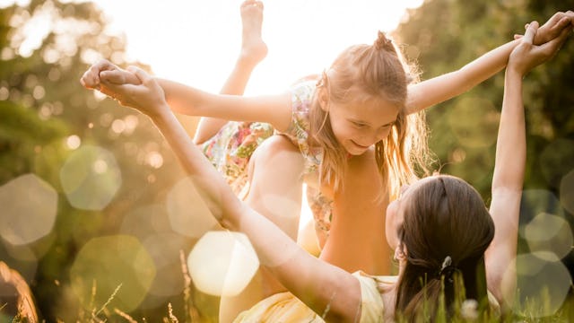 A mother playing with her eight-year-old daughter who has ADHD during summer break