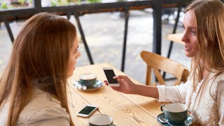 A newly divorced woman sitting with her married friend in a café