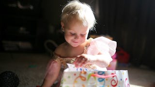 A child dressed like a princess playing with toys