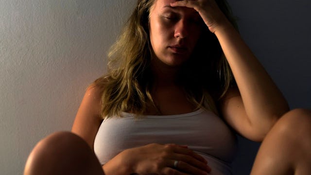 woman touching her pregnant belly