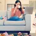 A woman drinking a hot beverage peacefully on the couch while surrounded by a mess of toys 