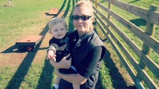 Kathy Soppet holding her kid who suffers from food allergies
