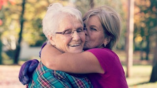 An older lady hugging her mother 