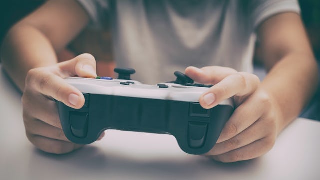 A child wearing a white shirt while playing Fortnite