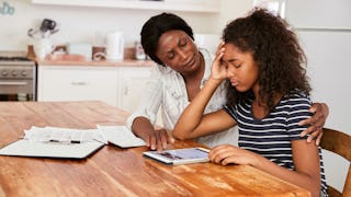 Mother and daughter sitting frustrated at a table