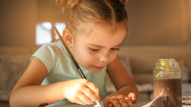 A little girl with a speech delay doing her homework 