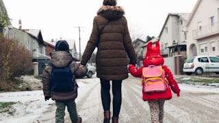 Mother taking her kids to the school 