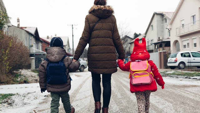 Mother taking her kids to the school