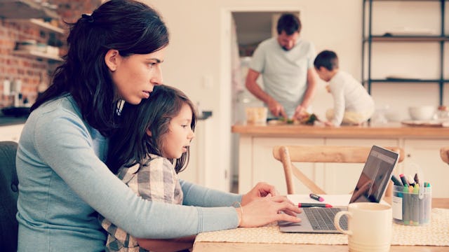 Two working parents with their two children, balancing home and work life