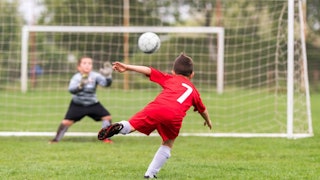 Two boys playing soccer 