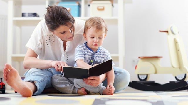 A mom reading a book to her toddler
