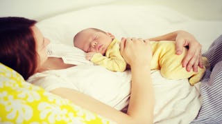 A baby sleeping on her mother