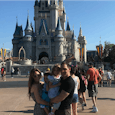 Family picture in Disney World where the son is wearing a dress 