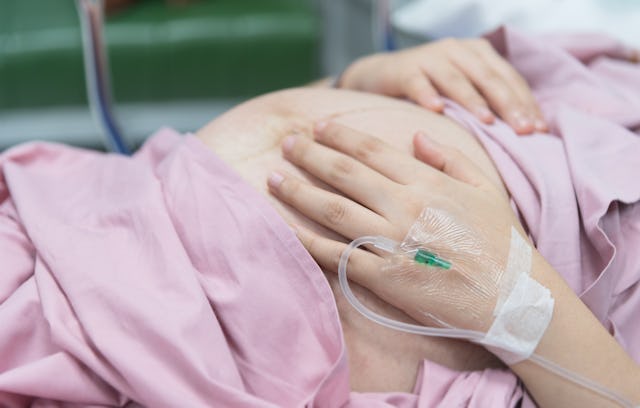 A pregnant woman in a hospital bed before experiencing a blood clot