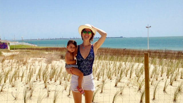 Grace McClintic holding her baby son at a beach after living outside America