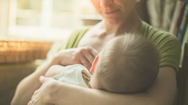 A mom breastfeeding her son in public
