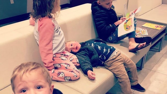 Four kids all over a couch 