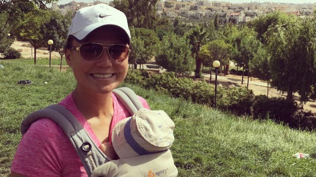 An introverted SAHM mum holding her baby in a carrier while on a hike