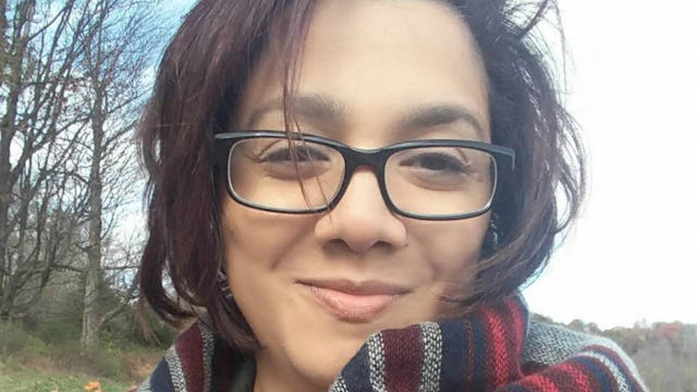 A woman with glasses who was motivated to live her best life after the death of a friend