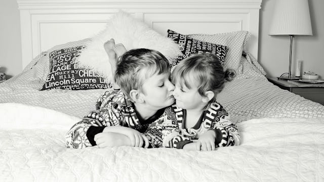 An older brother kissing his sister 
