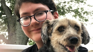 A boy holding his puppy 