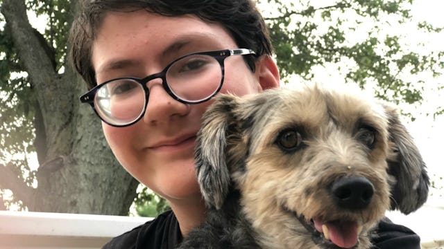 A boy holding his puppy